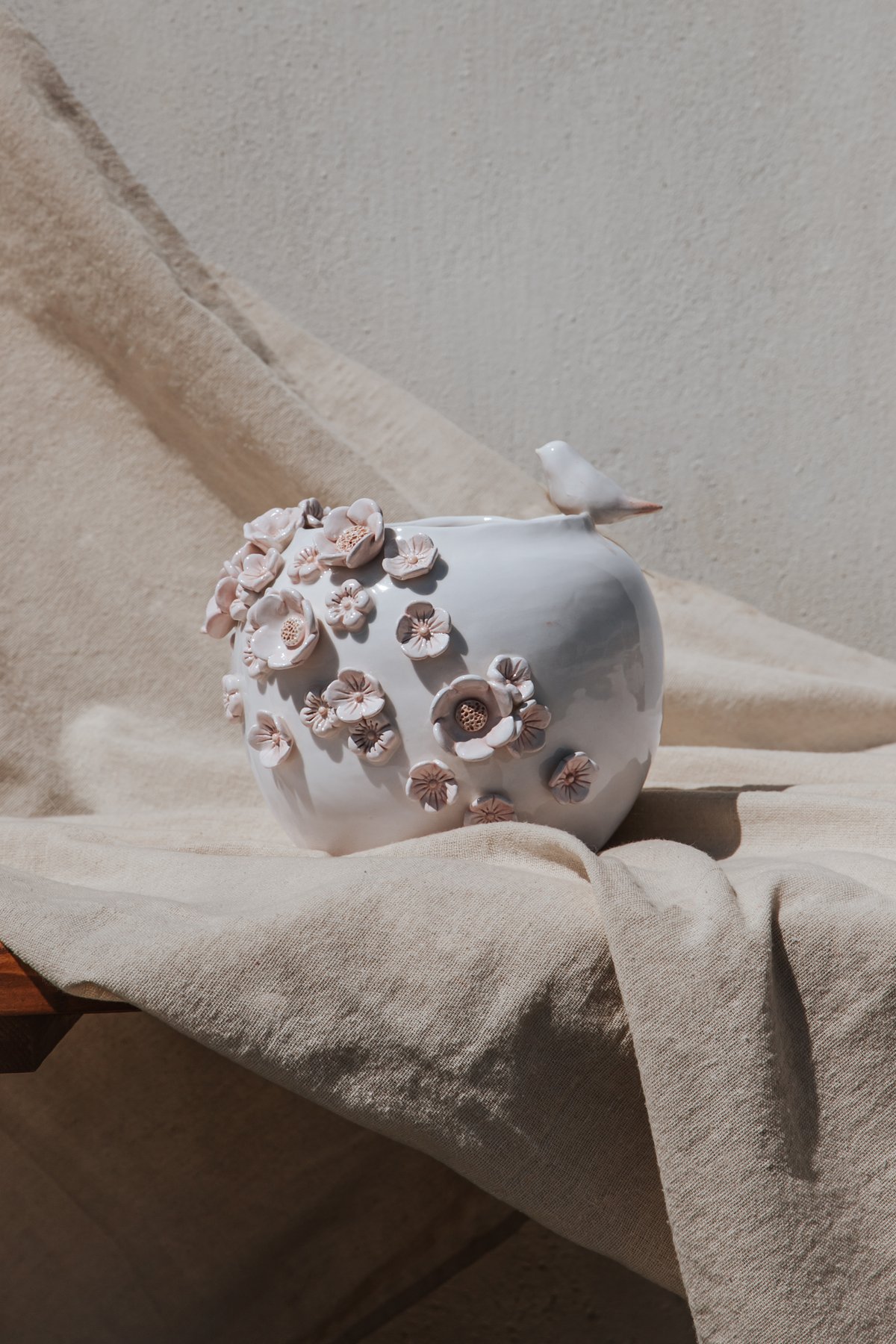 Narrative Ceramics &mdash; close view of the hand-modelled blossoms embracing the form