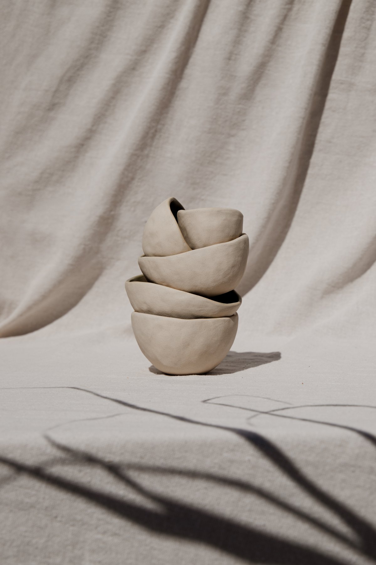 The Nesting Bowls &mdash; three hand-sculpted bowls stacked, with asymmetrical rims