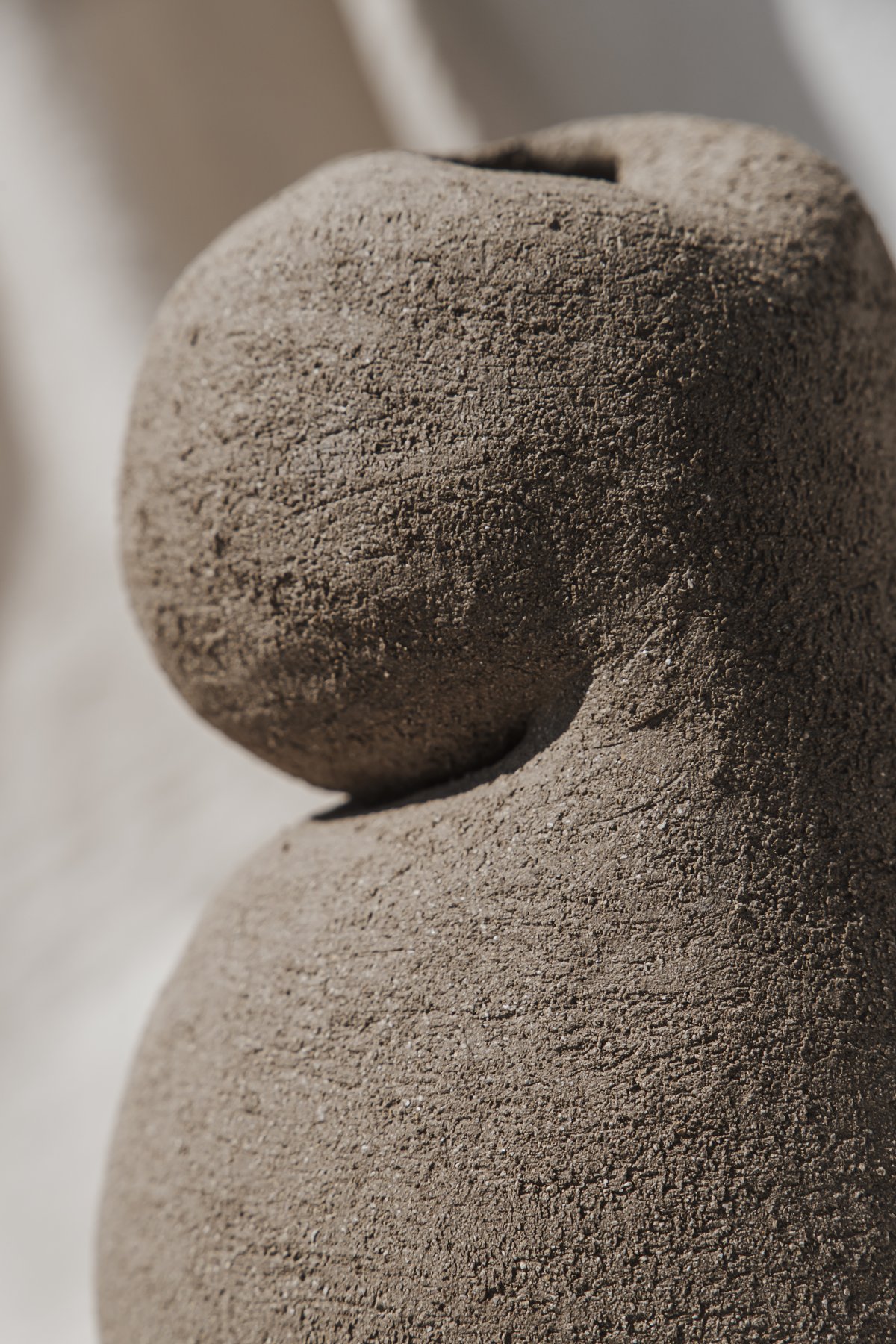 Primal Touch &mdash; the stacked stone-like silhouette seen against linen