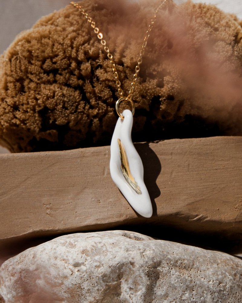 The Porcelain Pendant &mdash; close-up of the gold accent at its centre