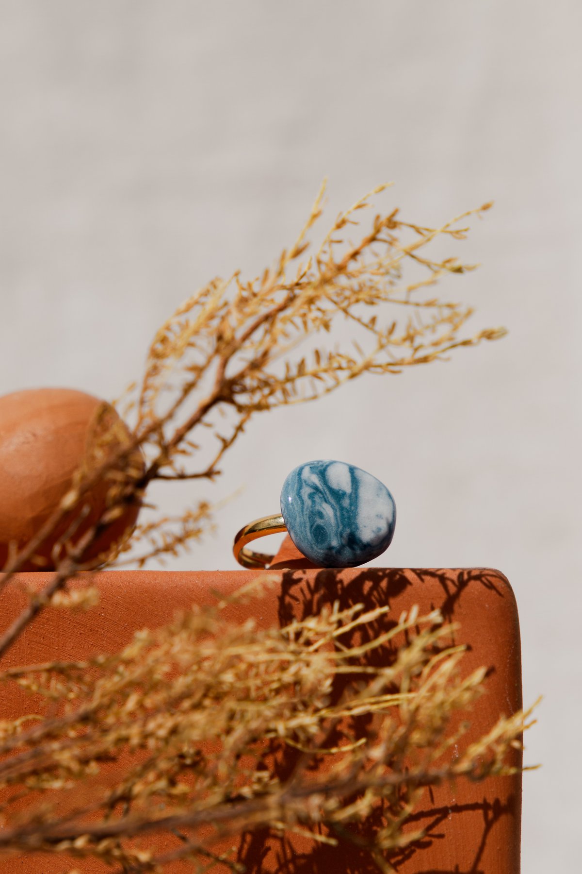 The Stone-Look Ring &mdash; a marbled blue porcelain ring on a gold-plated band